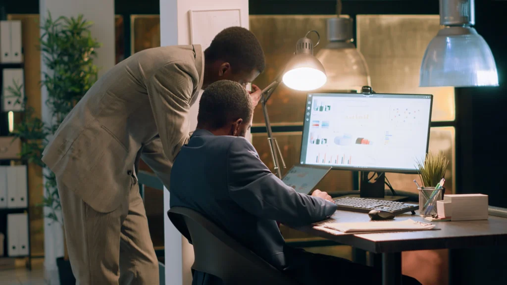 coworkers office crosschecking datasets comparing financial charts checking business figures nightshift experienced businessmen helping eachother finish project tasks faster compressed